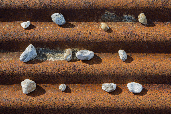 Pebbles on Rust Picture Board by David Hare