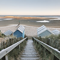 Buy canvas prints of Frost covered beach huts at sunrise. Wells-next-the-sea, Norfolk, UK. by Liam Grant