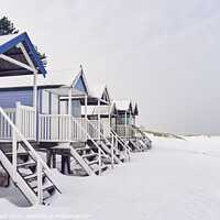 Buy canvas prints of Beach huts covered in snow at low tide. Wells-next-the-sea, Norf by Liam Grant
