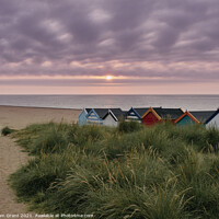 Buy canvas prints of UK, Suffolk, Southwold, Sunrise over multi coloured beach huts by Liam Grant
