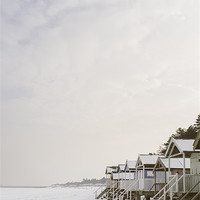 Buy canvas prints of Beach huts covered in snow. by Liam Grant