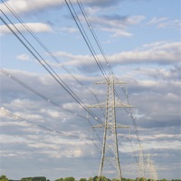 Buy canvas prints of Evening light illuminating electricity pylons. by Liam Grant