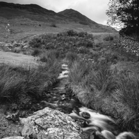 Buy canvas prints of Cinnerdale Beck above Crummock Water with Whiteles by Liam Grant