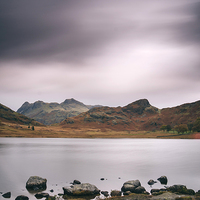 Buy canvas prints of Clouds over Blea Tarn with Langdale Pikes beyond. by Liam Grant