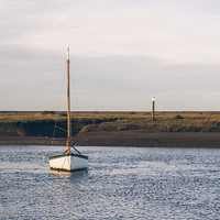 Buy canvas prints of Boat and marshes. Burnham Overy Staithe. by Liam Grant
