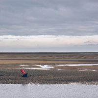 Buy canvas prints of Low tide and distant wind farm. Wells-next-the-sea by Liam Grant