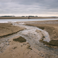 Buy canvas prints of Low tide and dark skies. by Liam Grant
