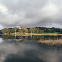Buy canvas prints of Sunlight and reflections on Esthwaite Water. by Liam Grant