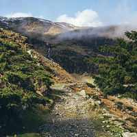 Buy canvas prints of Mountain footpath and distant waterfall near Conis by Liam Grant