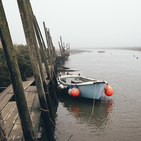 Buy canvas prints of Boats moored at Blakeney in fog. by Liam Grant