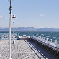 Buy canvas prints of Lamp and seating on Mumbles Pier. Wales, UK. by Liam Grant