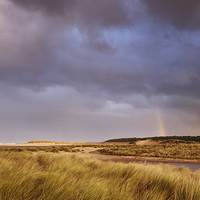 Buy canvas prints of Storm clouds and rainbow at sunset. Holkham, Norfo by Liam Grant