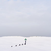 Buy canvas prints of Groyne and beach covered in snow at low tide. Well by Liam Grant