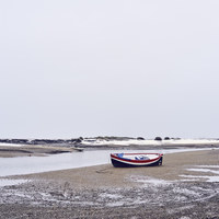 Buy canvas prints of Boats and snow at low tide. Burnham Overy Staithe, by Liam Grant