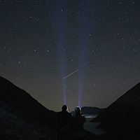 Buy canvas prints of Young couple watching shooting stars in the mounta by Liam Grant