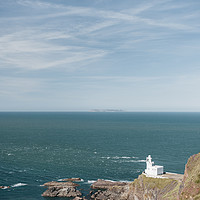 Buy canvas prints of Lighthouse at Hartland Quay with Lundy Island beyo by Liam Grant