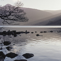 Buy canvas prints of Shafts of sunlight at sunset of Crummock Water. Cu by Liam Grant