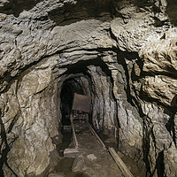 Buy canvas prints of Mine cart in an old abandoned mine cave. Near Matl by Liam Grant