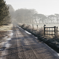 Buy canvas prints of Remote frozen country road at sunrise. Norfolk, UK by Liam Grant