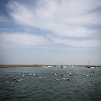 Buy canvas prints of Norfolk Swimmers by Simon Wrigglesworth