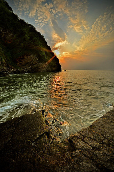 Sunset at Lee Abbey Bay Picture Board by graham young