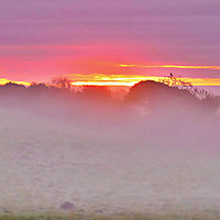 Buy canvas prints of Sunrise Through The Mist by Nicola Clark