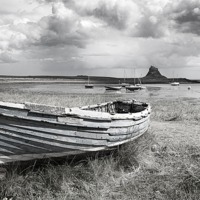 Buy canvas prints of Lindisfarne Castle and Boat by Dave Turner