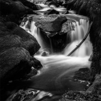 Buy canvas prints of Black and white waterfall over rocks by Izzy Standbridge
