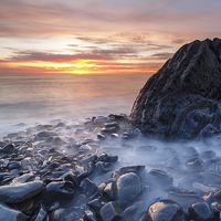 Buy canvas prints of Aberystwyth rocky sunset by Izzy Standbridge