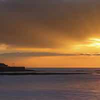 Buy canvas prints of  Aberystwyth winter sunset over smooth seas by Izzy Standbridge