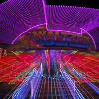 Buy canvas prints of  Zoomburst picture of the Waltzer funfair ride by Izzy Standbridge