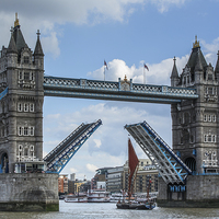 Buy canvas prints of   Tower Bridge opens for a sailing barge by Izzy Standbridge