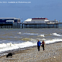 Buy canvas prints of Walking the dog at on Cromer beach by Darren Burroughs