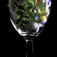 Buy canvas prints of a glass of Marbles by Doug McRae