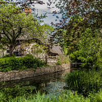 Buy canvas prints of Thatched cottage by the river Lambourn  by Jim Hellier