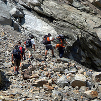 Buy canvas prints of Trekkers Climbing over Landslide by Serena Bowles