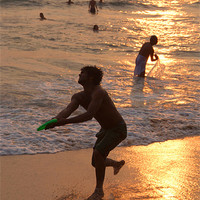 Buy canvas prints of Frisbee Thrower on Varkala Beach at Sunset by Serena Bowles
