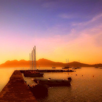 Buy canvas prints of Puerto Pollensa Misty Sun Up by Louise Godwin