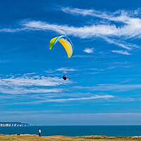 Buy canvas prints of Paragliding at Barton on Sea by Joyce Storey