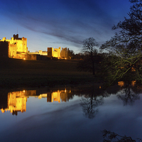 Buy canvas prints of Alnwick Castle Dusk Reflection by Paul Appleby