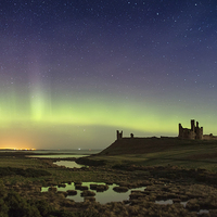Buy canvas prints of Dunstanburgh Castle Aurora New Years Day 2016 by Paul Appleby