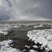 Buy canvas prints of Snow showers over Buachaille Etive Mor. by John Cameron