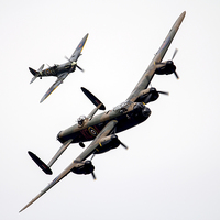Buy canvas prints of BBMF Lancaster and Spitfire  by J Biggadike