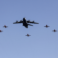 Buy canvas prints of A400M with Red Arrows  by J Biggadike