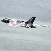 Buy canvas prints of Vulcan XH558 Over The Water by J Biggadike
