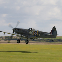 Buy canvas prints of Spitfire TE311Grass Landing by J Biggadike