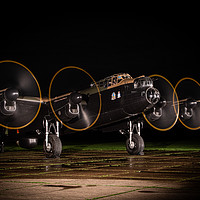 Buy canvas prints of Lancaster Bomber Night Shoot by J Biggadike