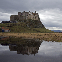 Buy canvas prints of Lindisfarne Castle reflection by John Biggadike