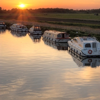 Buy canvas prints of Sunset at Acle Bridge by Dan Davidson