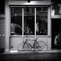 Buy canvas prints of Shop Front with Bicycle by Lynn Bolt